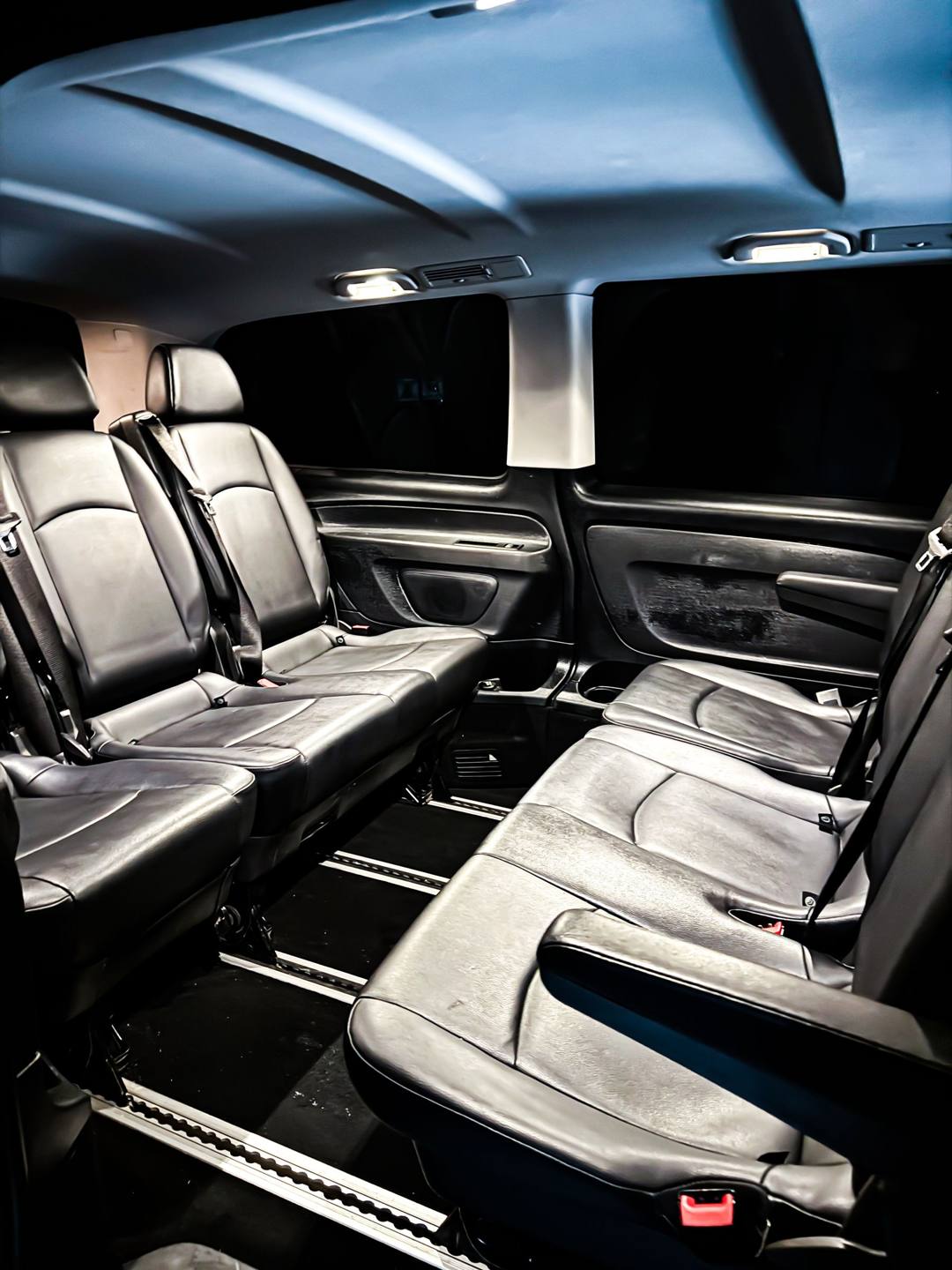 Black leather passenger seats inside a Mercedes-Benz van